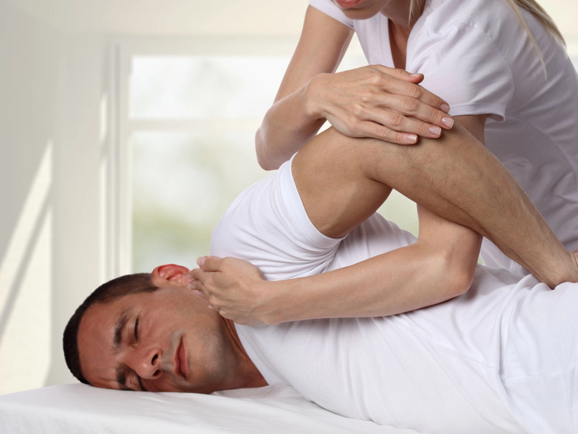 ein Mann lässt sich physiotherapeutisch behandeln